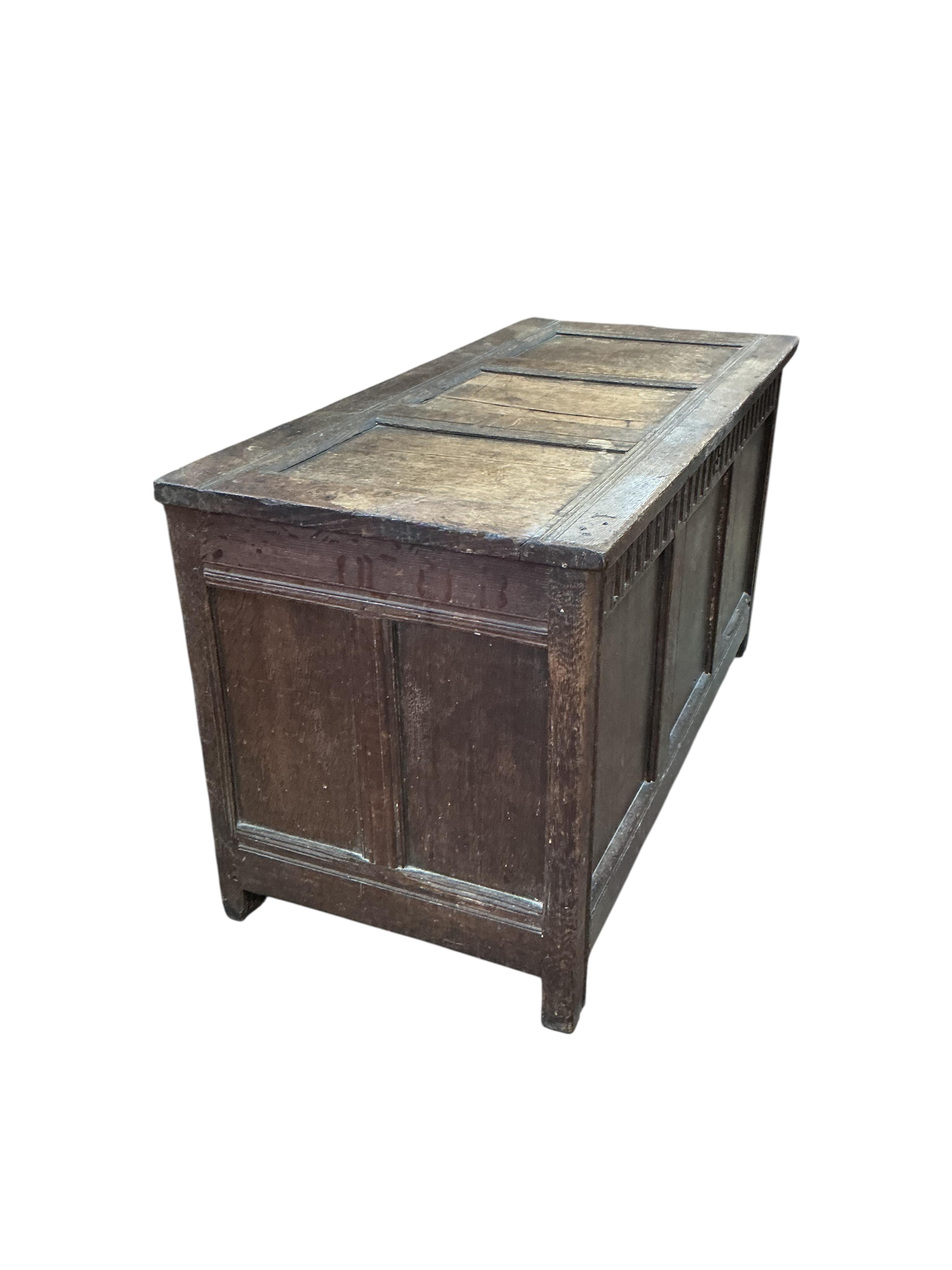 An 18th century panelled oak coffer, width 117cm, depth 54cm, height 64cm